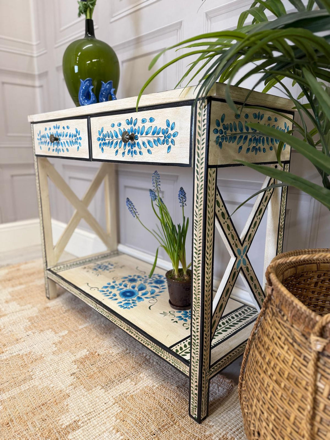 Consola pintada a mano, acabado crema con detalles florales en turquesa y dos cajones.